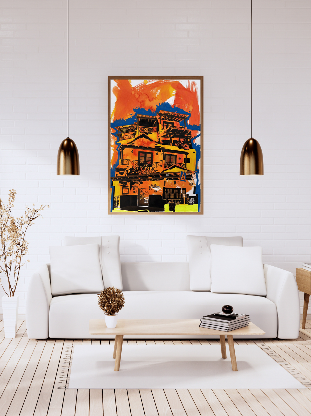 A framed colorful painting of a building hangs on a white brick wall above a white sofa in a modern living room setting with two hanging lamps.