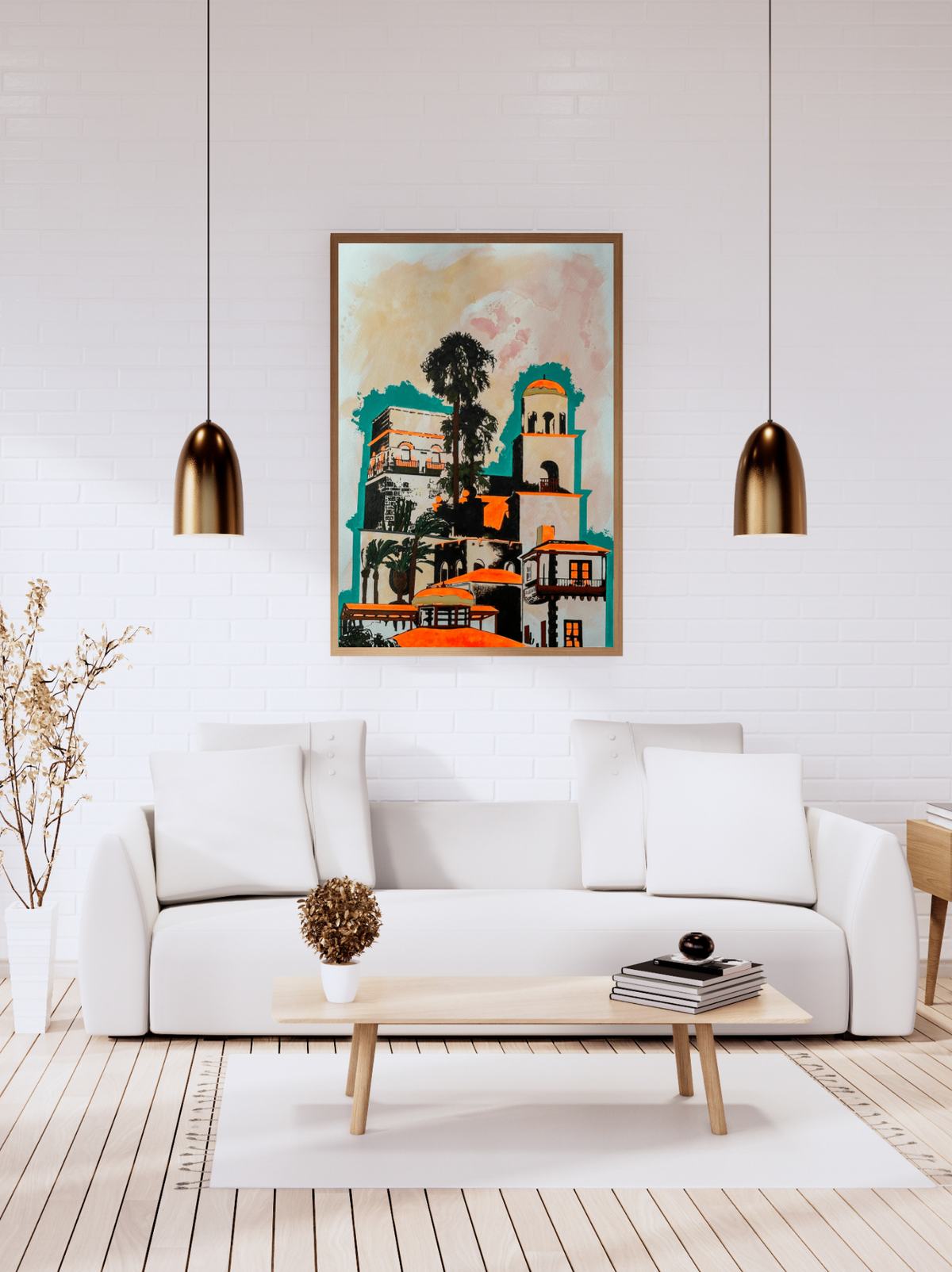 A framed colorful painting of a historic building complex hangs on a white brick wall above a modern white sofa in a bright, contemporary living room.