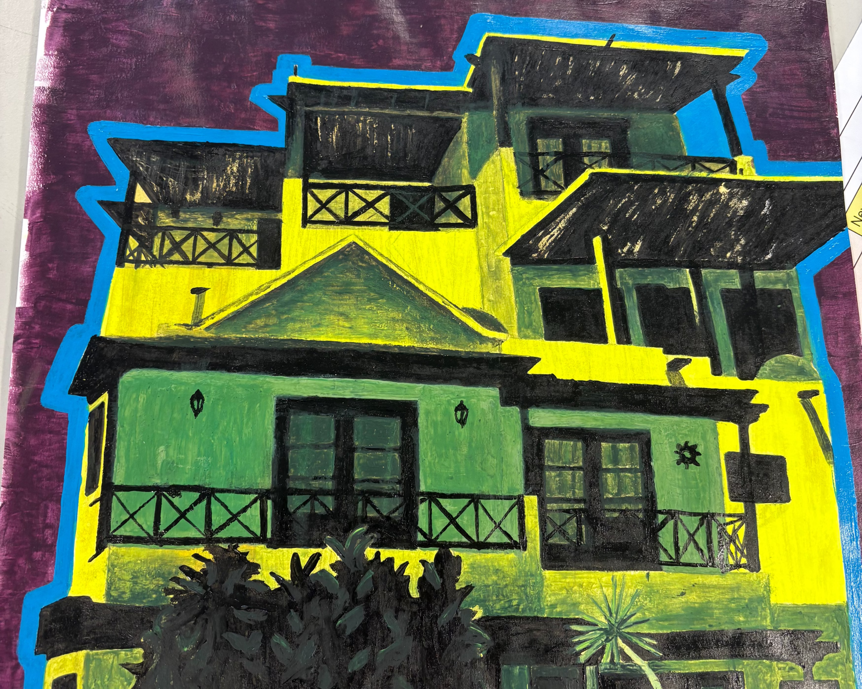 A colorful pop-art style painting of a multi-story building with bright yellow and green walls, black windows and balconies, a dark purple background, and bold blue outlines, photographed on a white surface.